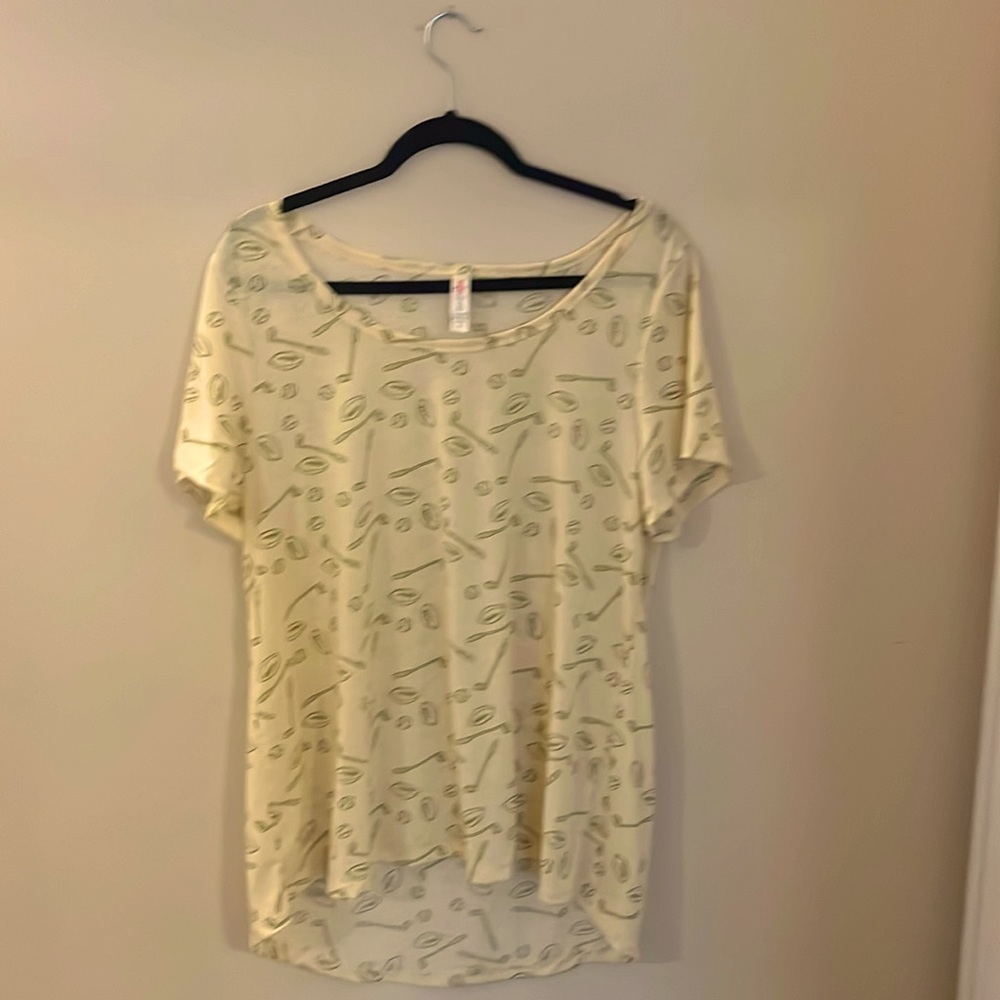 LuLaRoe Classic Tee size XL cream with green footballs baseballs and golf clubs